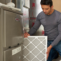 man changing out air filter
